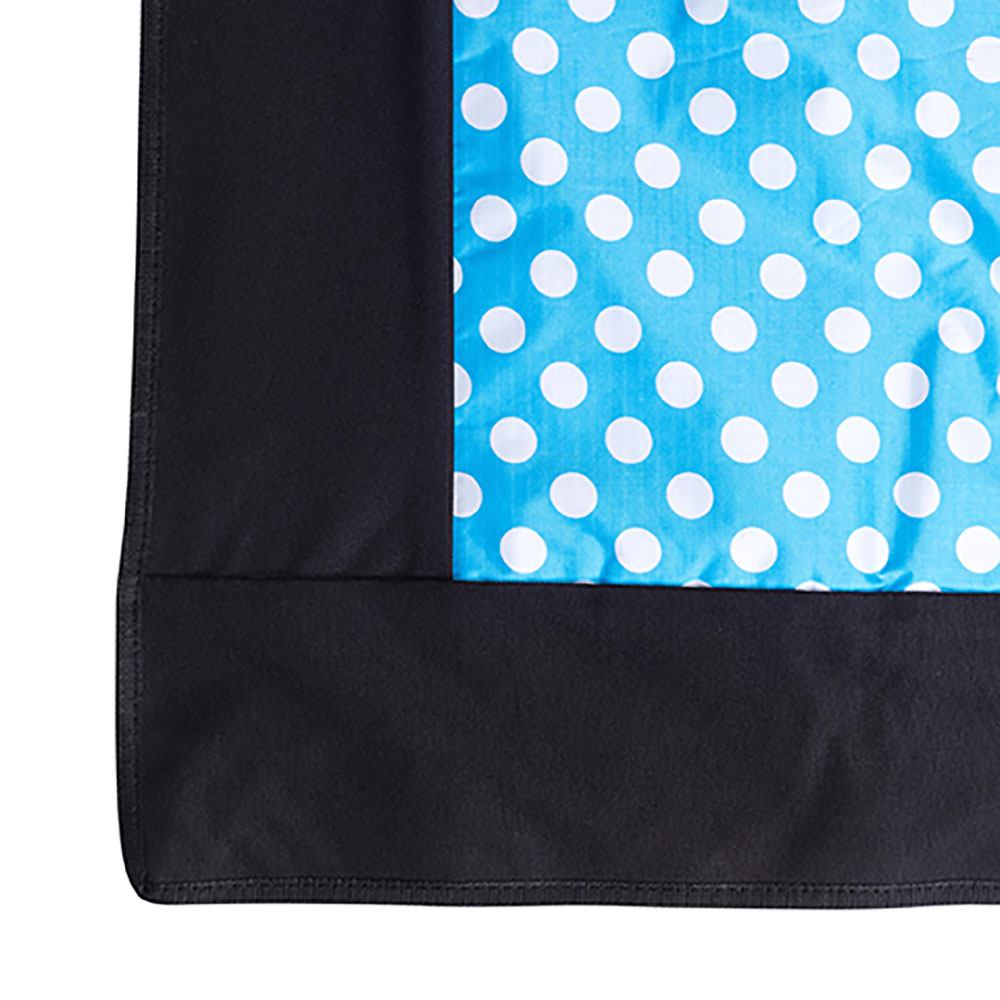 picnic rug edge with blue and white polka dots in carry bag